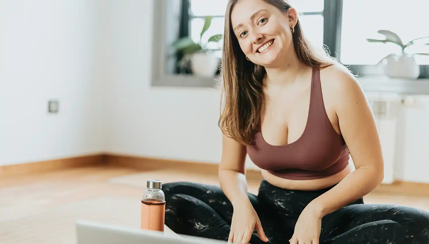 Happy, healthy woman in yoga with a little bit of extra weight that could be helped with liposuction