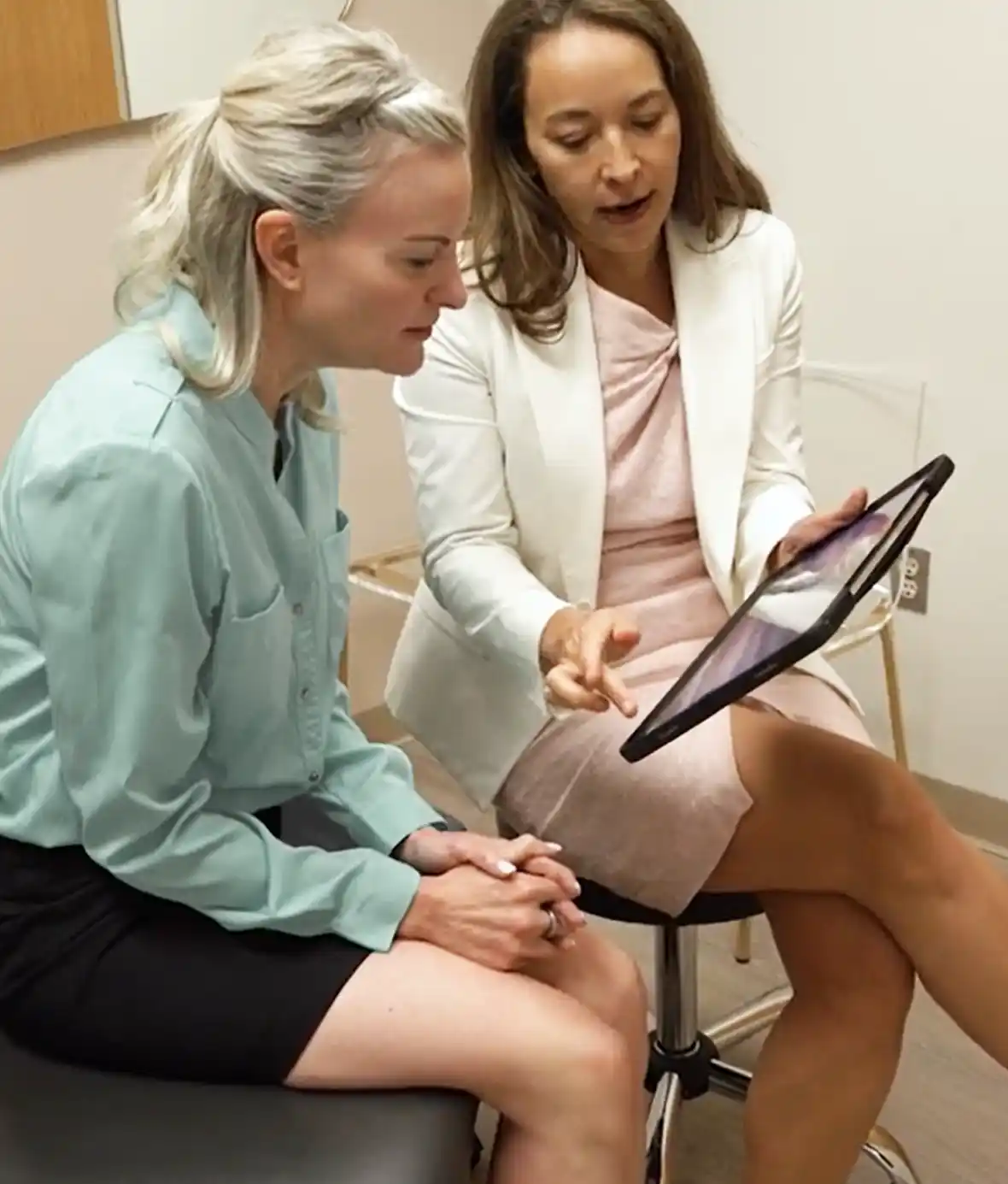 Dr. Aycock and patient reviewing tablet in office