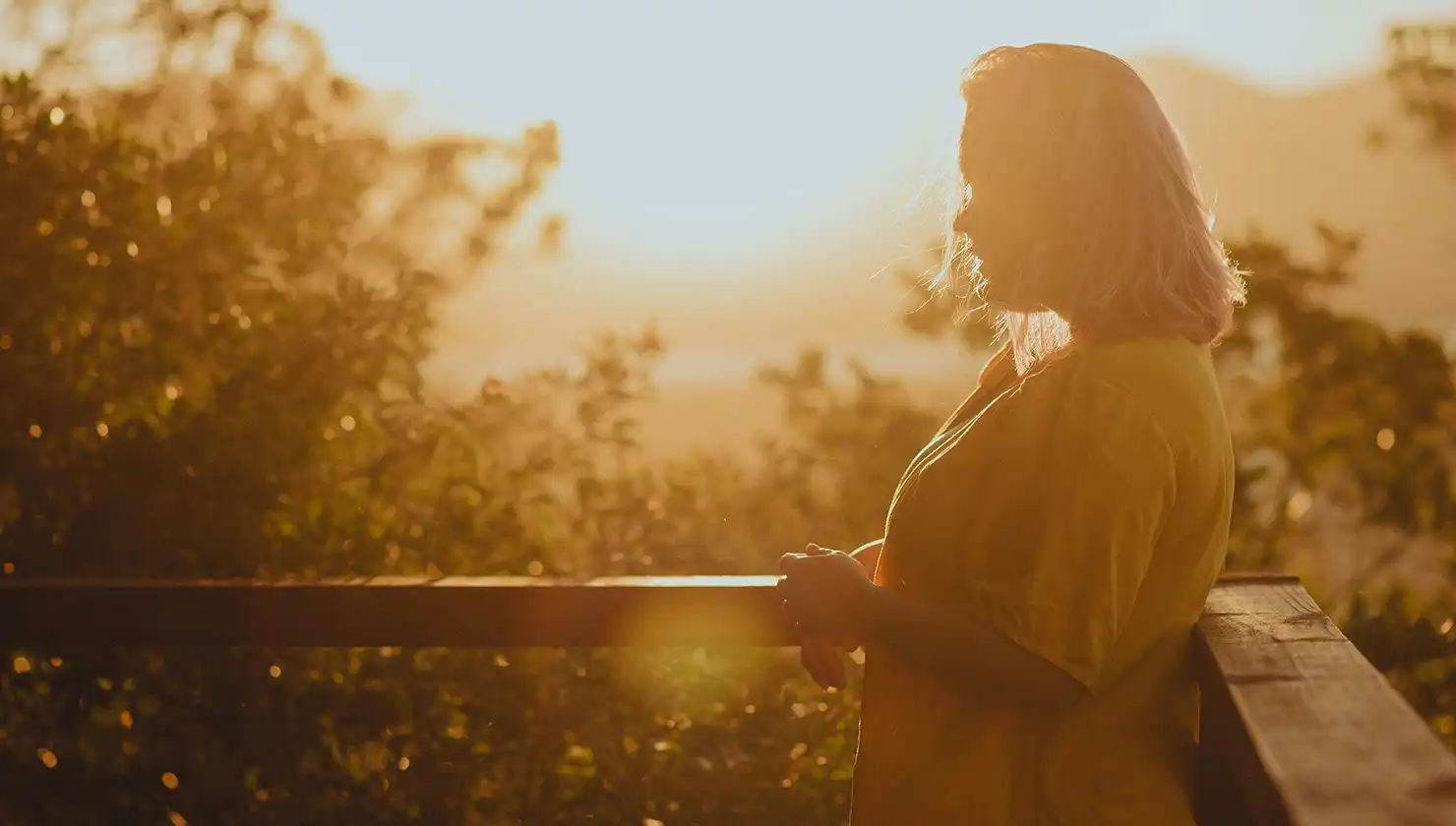 potential female brachioplasty patient standing in sunrise light
