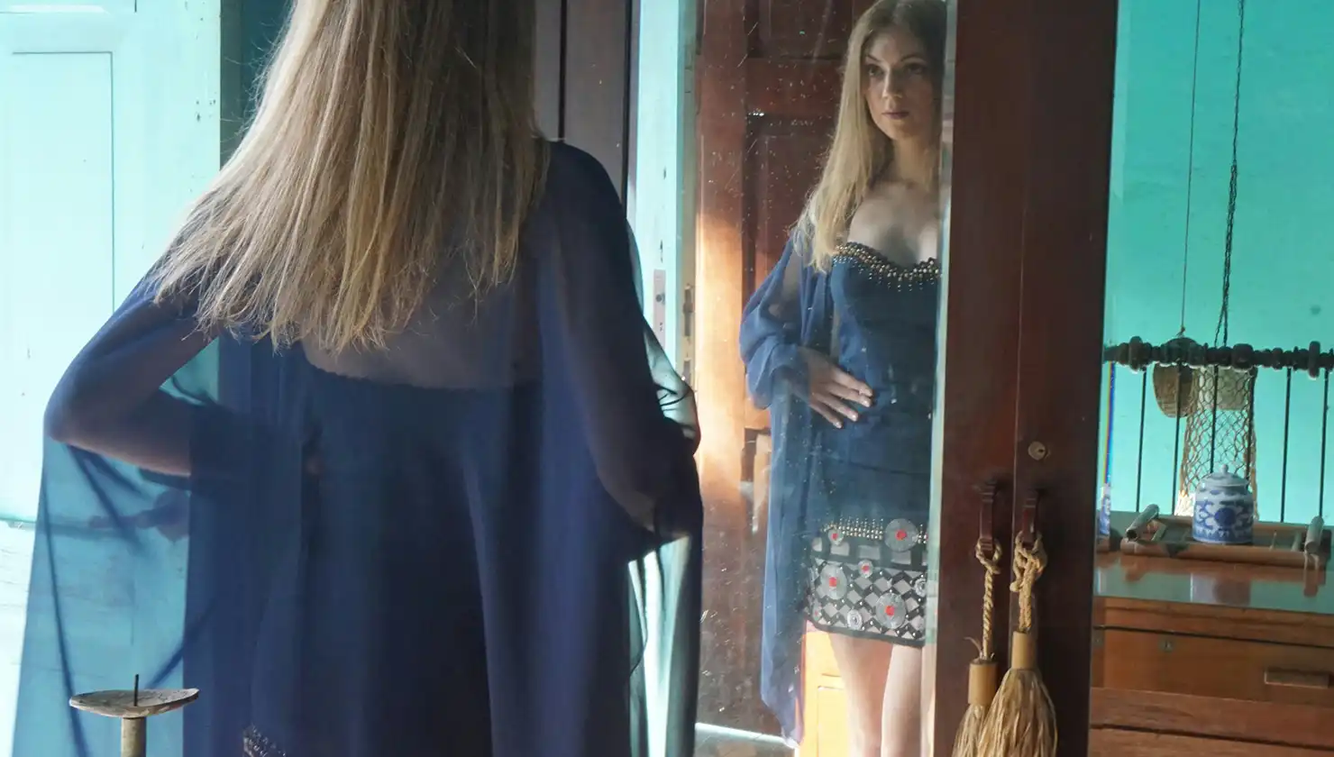 Potential labiaplasty and clitoral hood reduction patient - Woman in front of mirror "Standing View" exam.