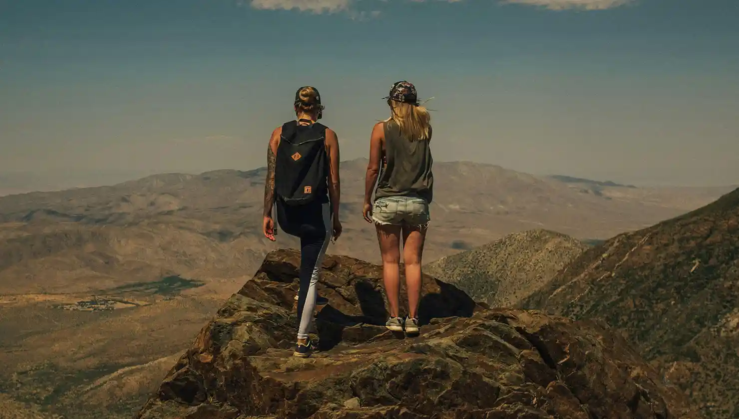two women at the top of a mountain finally able to live the active, outdoor life she had worked so hard for - potential patient for body contouring after weight loss